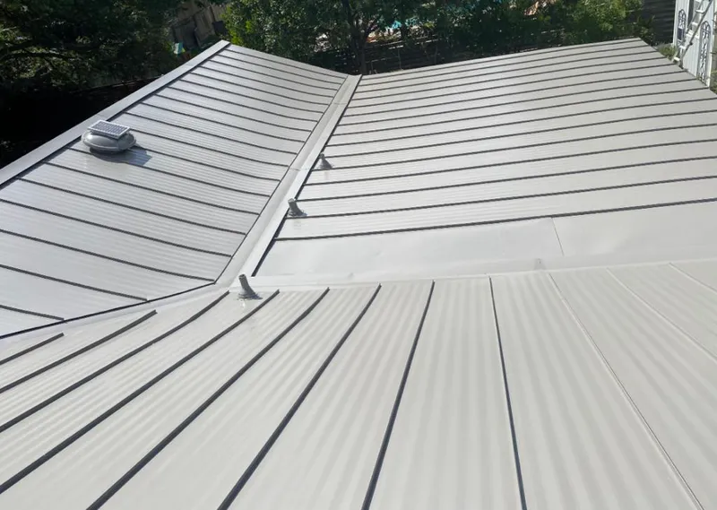 Solar attic fan installed on a metal roof for Roof Ventilation in Los Angeles